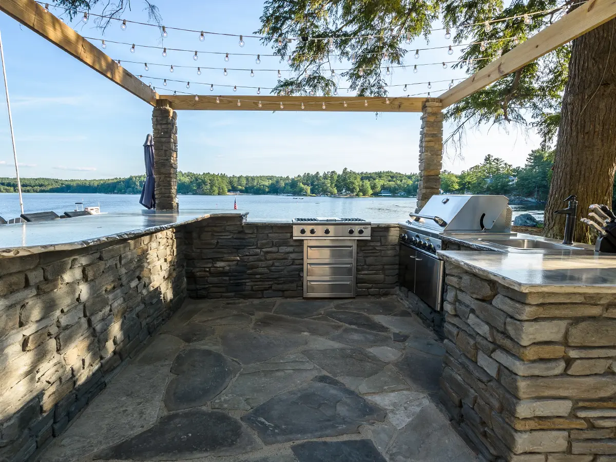 beautiful rectangular outdoor kitchen in front of lake