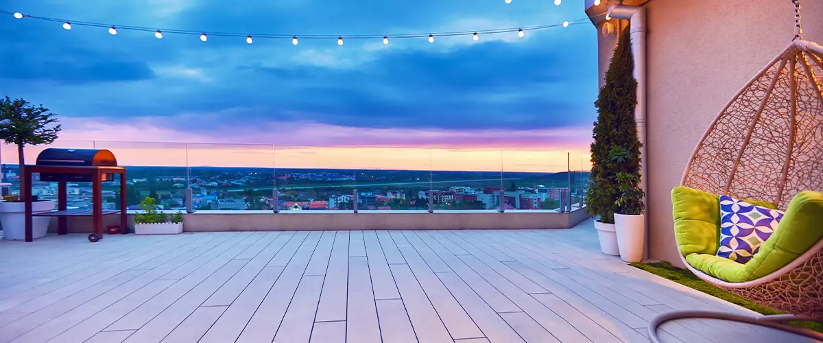Rooftop deck with cozy swing chair and stunning sunset view