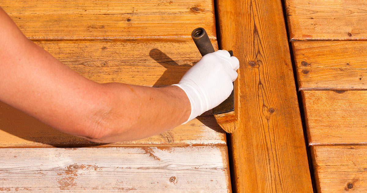 Wooden deck maintenance apply stain on decking