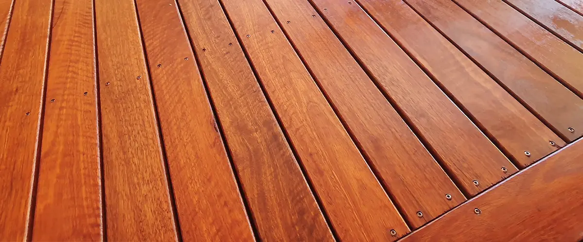 Close-up of new wooden deck boards with transparent staining