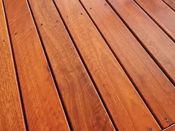 Close-up of new wooden deck boards with transparent staining